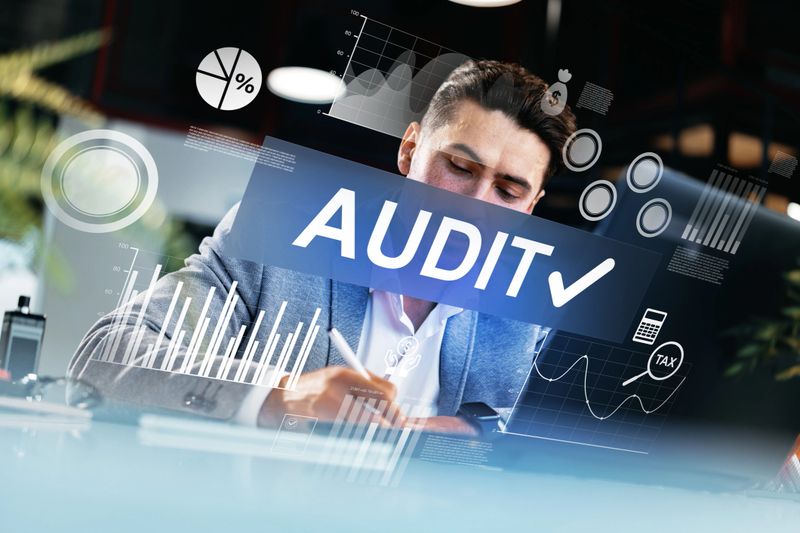 Businessman reviews financial data and prepares for an audit using digital technology.