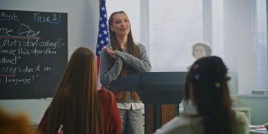 Woman giving a presentation in a classroom.