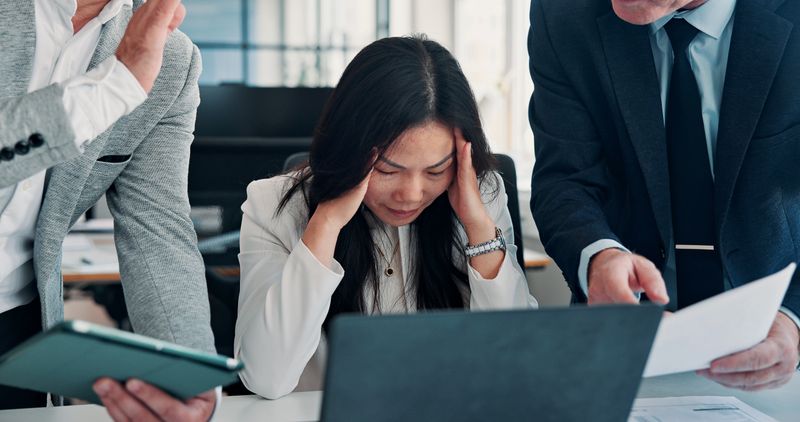 Frustrated woman, headache or laptop with stress for multitasking, overworked or pressure in office. Female person, team or demanding colleagues with migraine, anxiety or deadline for tasks or strain