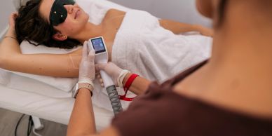 Woman getting laser hair removal on her armpit.