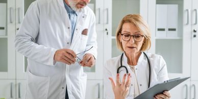 Two doctors discussing patient information in a medical office.