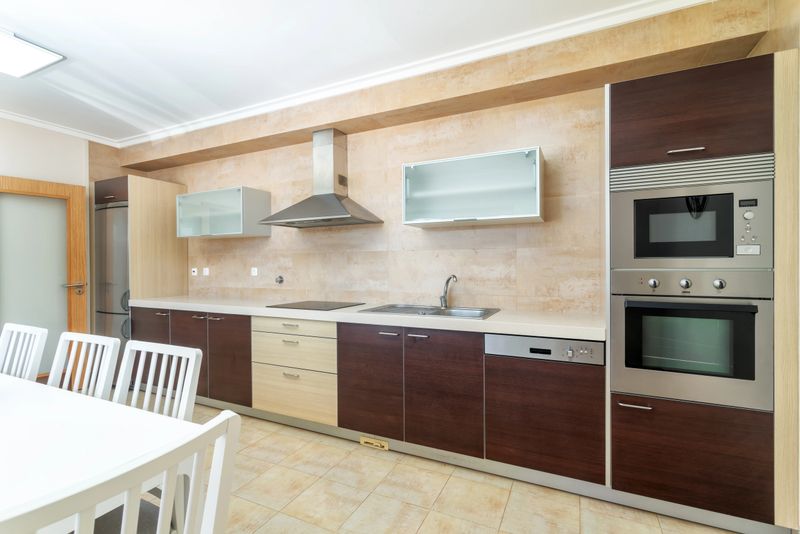 Bright and stylish kitchen features modern cabinets, sleek appliances, and ample workspace, perfect for cooking and entertaining in a family home.