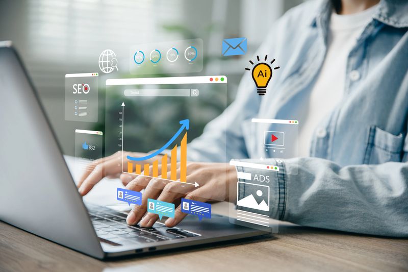 Digital marketing concept, Woman using laptop to monitor online advertising metrics through a digital dashboard.