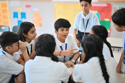 In the classroom student Discussing each other