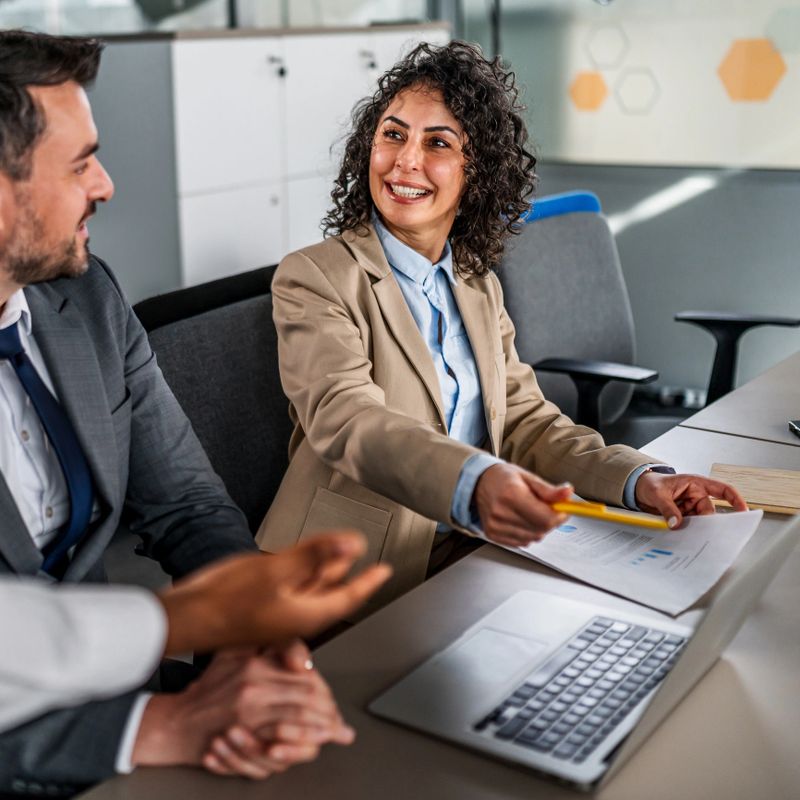 Business colleagues in an office meeting collaborating, discussing project strategies and analyzing data