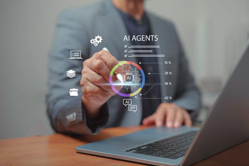 A business professional using AI agents on a laptop, showcasing automation, data analysis, and digital transformation for smarter workflow optimization and advanced tech innovation in modern workplaces.