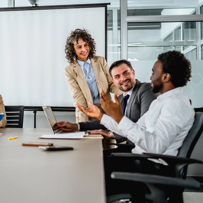 Group of multi-ethnic business people discussing ideas and collaborating during a professional meeting in a conference room