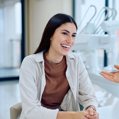 A happy young woman smiling during a consultation.