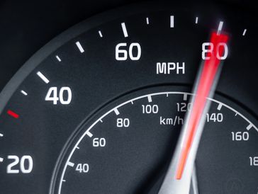 Speedometer showing about 80 mph.
