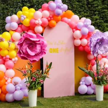 Colorful balloon decor with flowers for a celebration.