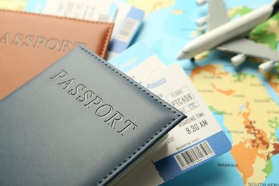 Passports, boarding passes, and a toy airplane on a world map.