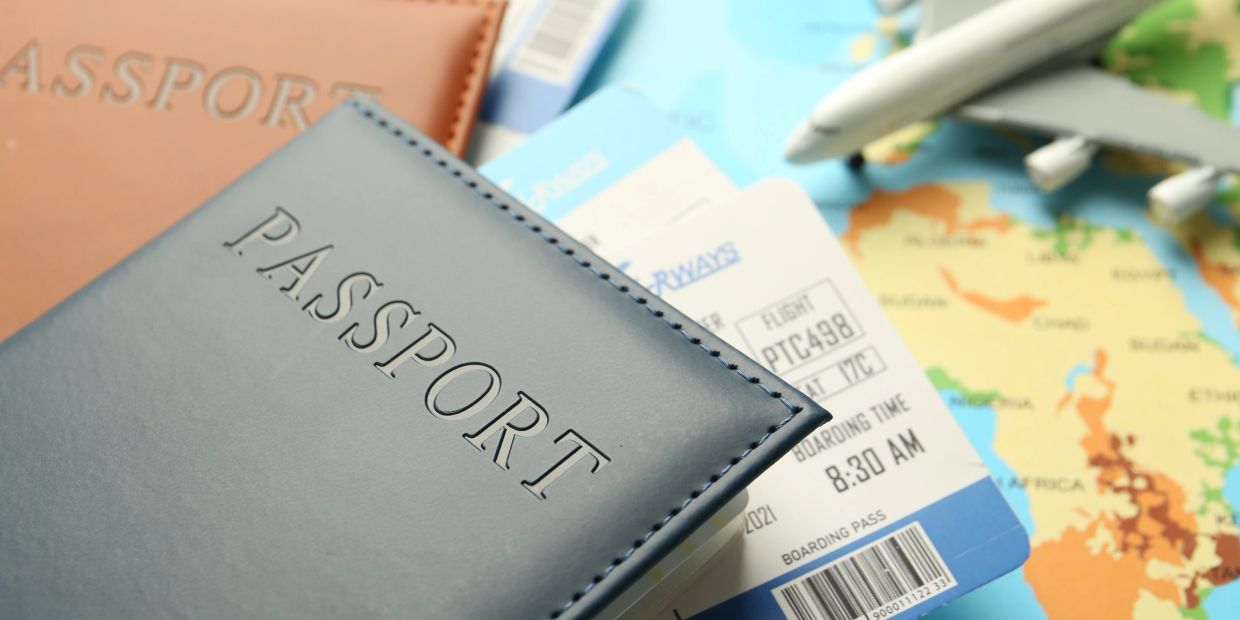 Passports and boarding passes with a toy airplane on a map.