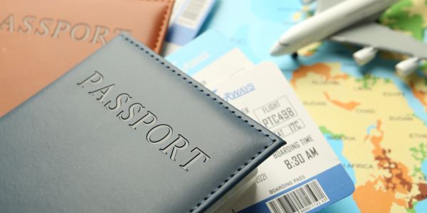 Passports, boarding passes, and airplane model on a map.