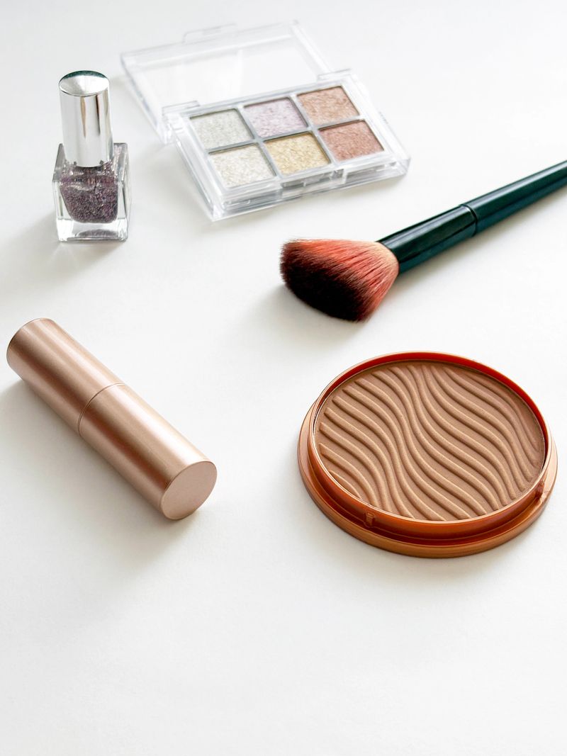 Make-up cosmetics products on white background. Lipstick, foundation make-up, make-up brush, eyeshadow palette, nail polish