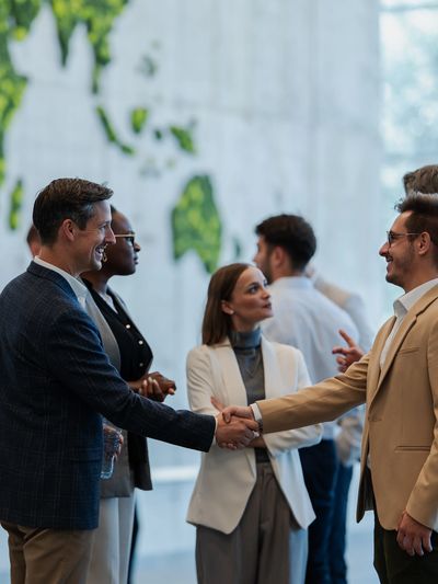 Two businessmen shaking hands during a networking event.