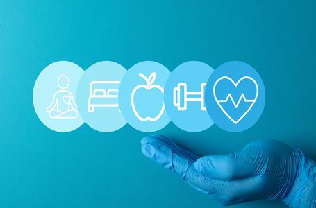 Hand with glove holding health and wellness icons.