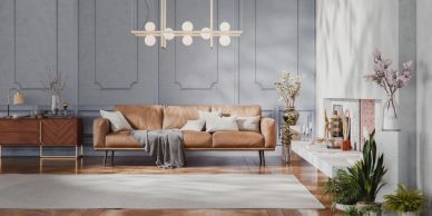 Modern living room with brown leather sofa and plants.