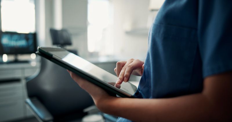 Hands, dentist and woman with tablet, internet and digital app for online schedule. Medical professional, oral health or person with tech, website info or research with checklist or compliance report