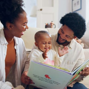 Family reading a book together.