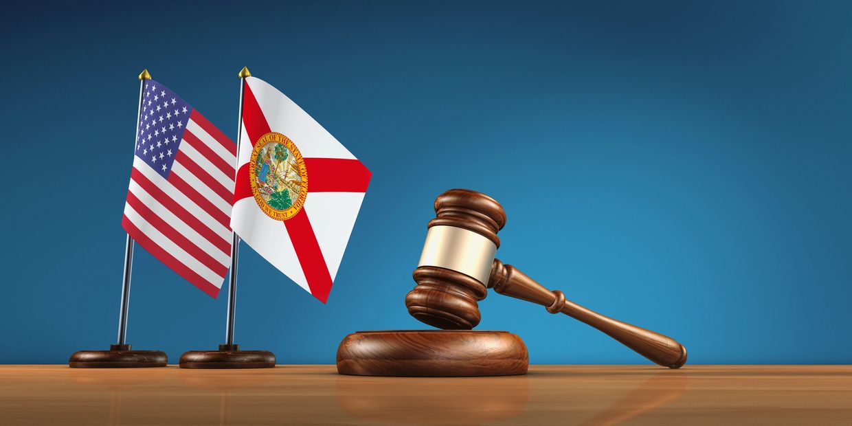 Wooden gavel with USA and Florida flags.