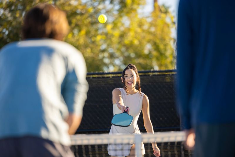 A group of friends playing pickleball.