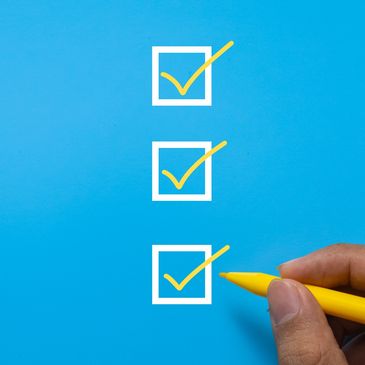 Hand marking checkboxes with a yellow pen.