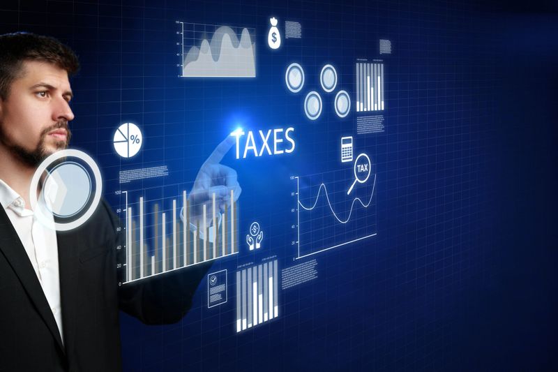 Professional man engages with interactive tax information on advanced technology screen.