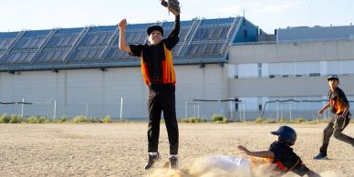 Youth baseball game with a player catching the ball.