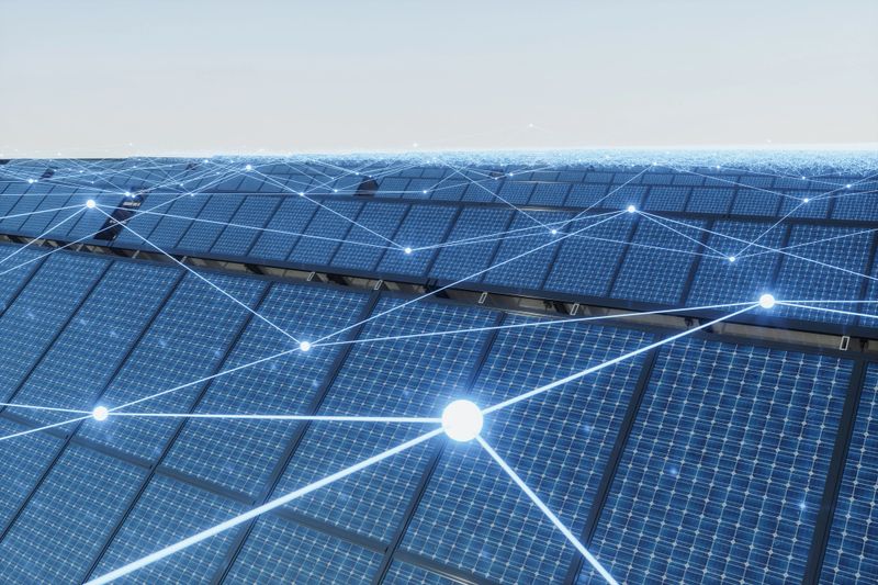 Rows of solar panels covered with a digital network overlay illustrating smart energy management and interconnected renewable power systems. The image represents advanced photovoltaic technology, data-driven efficiency, and the future of intelligent clean energy infrastructure.
