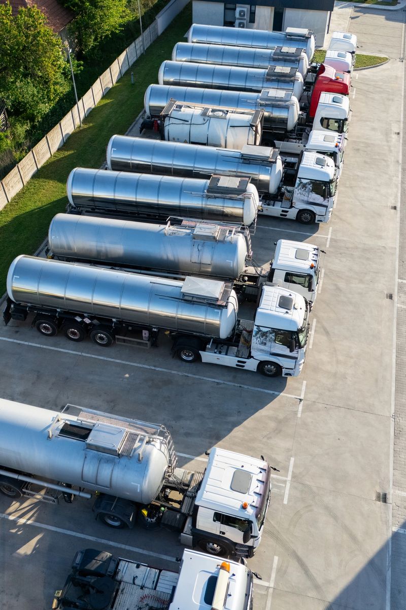 Fleet of trucks with tank trailers. Drone point of view.