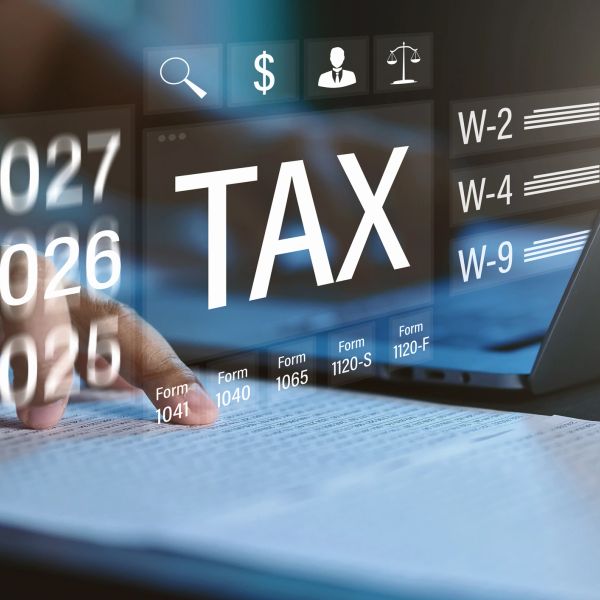 Digital tax filing with laptop and forms.