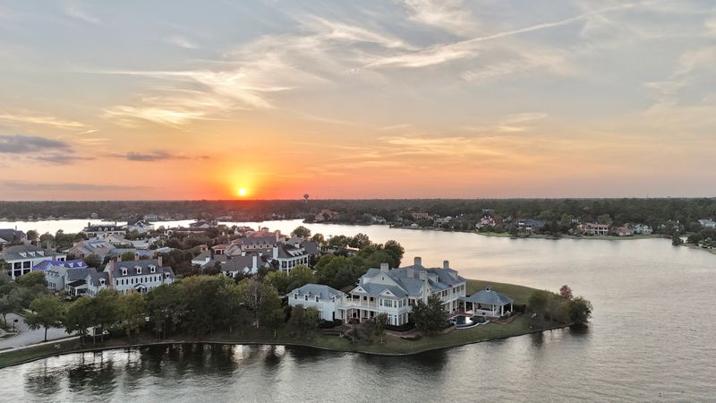Large mansion houses with swimming pool, in affluent neighborhood metroplex, expensive suburban homes surrounding by lush green trees, aerial view, Texas, USA by sunset time