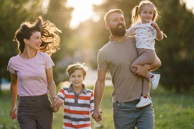 Family walking together outdoors in warm sunlight