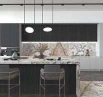 Modern kitchen with marble countertops and pendant lights.