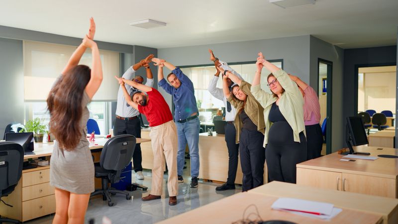 A group of multiracial business people are exercising and  stretching for a healthy office life in the office.