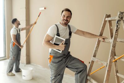 Empire Finish Co painter rolling fresh paint onto an interior wall