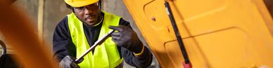 Close-up of hydraulic system and tire in heavy machinery.