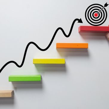 Colorful steps leading upward with a target symbolizing goal achievement.