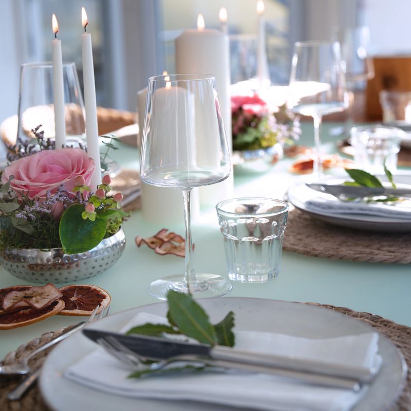 A festively set table for a wedding dinner. Tastefully decorated restaurant background with short depth of field.