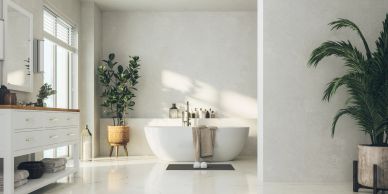 Modern bathroom with a freestanding bathtub and plants.