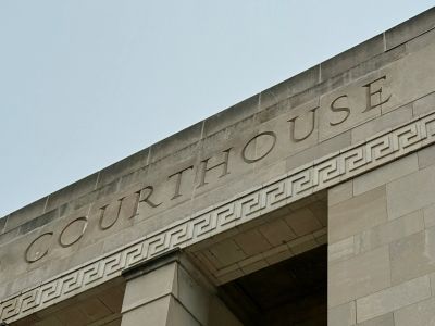 Stone courthouse building with the word 'COURTHOUSE' engraved.