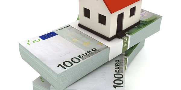 House model on stacks of 100 euro bills