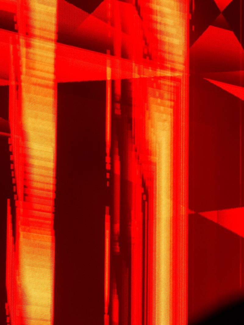 Abstract digital glitch art creating a vibrant background with red and orange distorted vertical lines and geometric fragments, depicting data chaos and technology