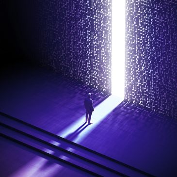 A person stands before a glowing doorway in a dark, futuristic room.