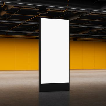 Blank vertical digital billboard in a modern indoor space with yellow walls.