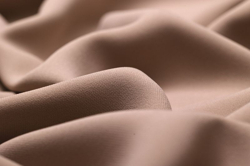 Close-up of delicate, lightweight georgette fabric, showcasing its soft, flowy texture and subtle drape, perfect for fashion, textiles, and design projects.