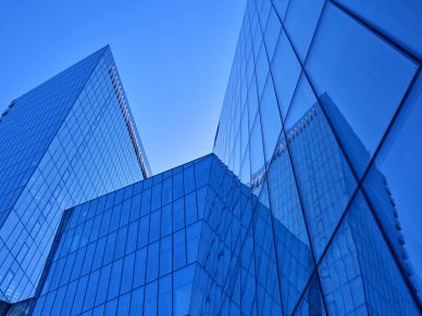 Glass office buildings against a clear blue sky.