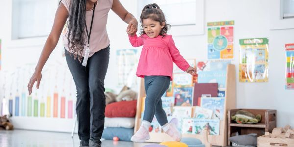 Adult and child playing and walking at home or school.
