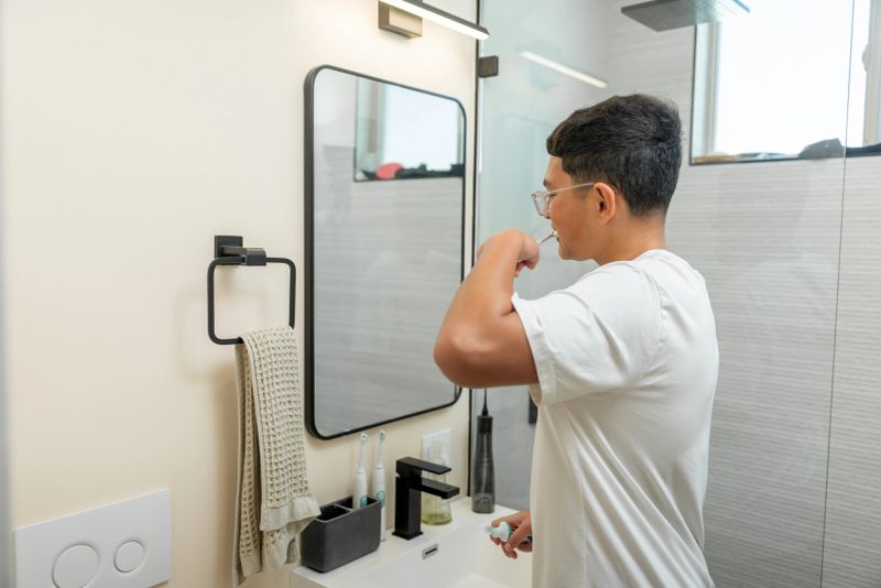 Teenage boy with braces exercising good dental hygine with an electrict toothbrush.