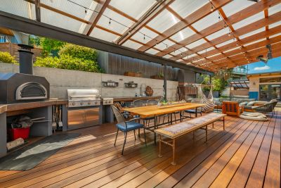 Spacious outdoor patio with dining area and barbecue setup.